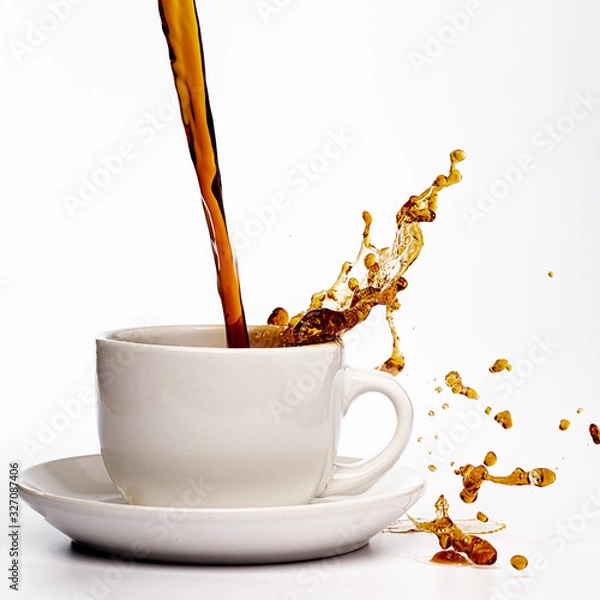 Fototapeta Coffee pouring into a white cup isolated against a plain white background, splashing in all directions creating a mess