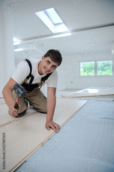 Fototapeta Professional Worker Installing New Laminated Wooden Floor