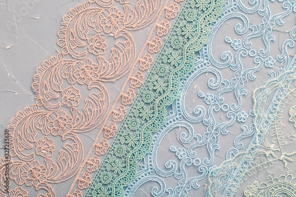 Obraz A variety of lace on a shabby background, a textile product with an ornamental design, openwork pattern formed by interweaving