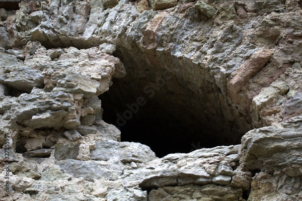 Obraz Window in an old medieval castle. Ruins, rough stone. Historical photography. The window arch is only half visible.