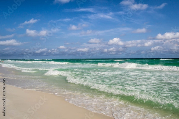 Fototapeta Turquoise waves rolling onto shore
