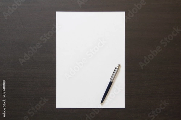 Fototapeta Template of white paper with pen on dark wenge color wooden background.