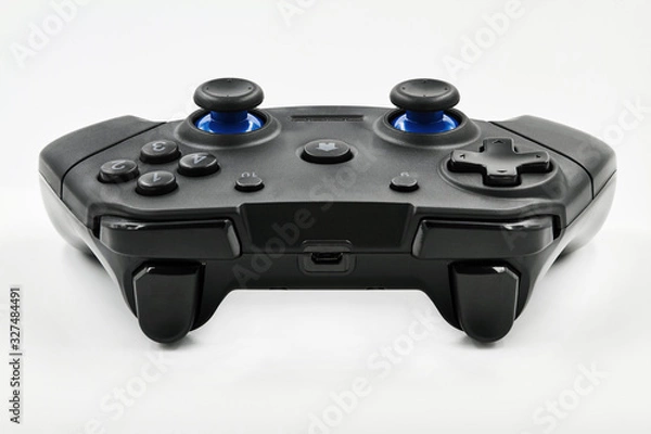 Fototapeta Gamepad on a white background. Game Joystick. Closeup, selective focus