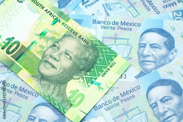 Fototapeta A close up image of a green ten rand bank note from South Africa in macro on a bed of Mexican twenty peso bank notes