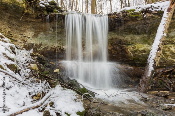 Fototapeta City Sigulda, Latvia. Waterfall in winter. White snow and trees. Travel photo.
