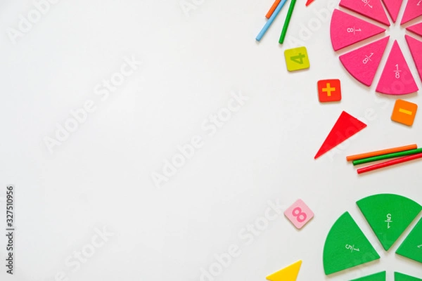 Fototapeta Mathematics background - fractions on white table, close up. Dividing fractions, math concept. Top view