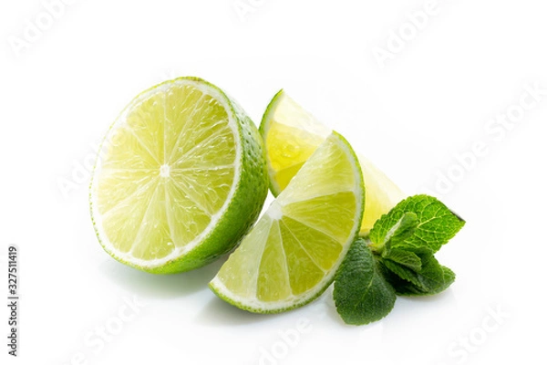 Fototapeta Fresh lime. Slices of ripe and juicy lime with green mint leaves close-up