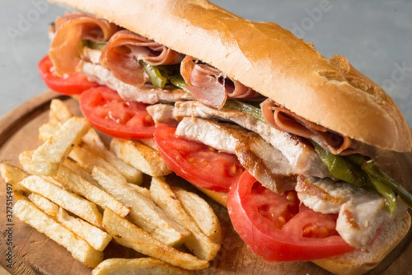 Obraz Sandwich Serranito typical in Andalusia with ham, green pepper and grilled pork loin