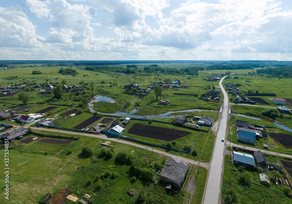 Fototapeta Aerial view of small river in Lipovskoe village. A lot of grass and trees. Russia, Sverdlovsk region
