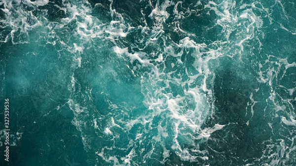 Fototapeta Background of the sea, clean deep ocean with air bubbles, foam on the surface of the ocean. foam composition on blue turquoise water.