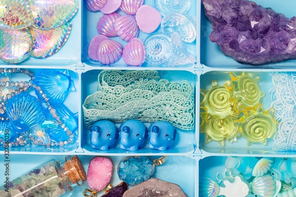 Fototapeta Toy figures of shells, elephants, fish, crystals, lace and other cute treasures in a box, all sorts of things for developing our imagination games and creativity