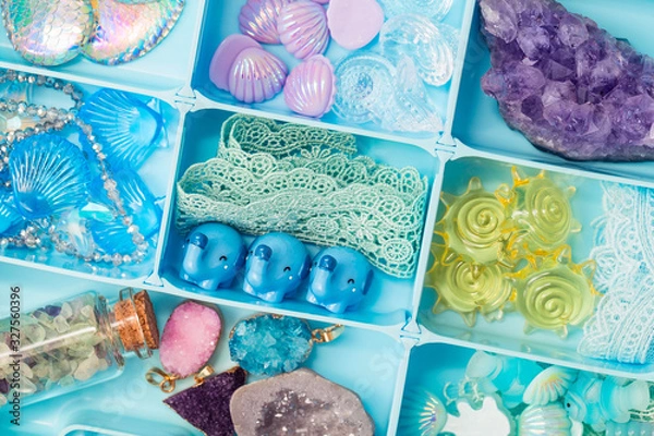 Fototapeta Toy figures of shells, elephants, fish, crystals, lace and other cute treasures in a box, all sorts of things for developing our imagination games and creativity