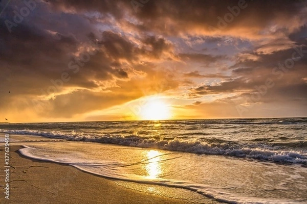 Obraz  colored sunset with cloud cover over the sunset at the beach - dramatic sunset on the baltic sea