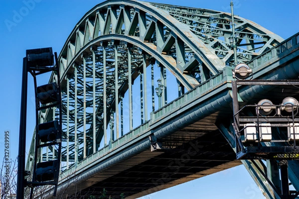 Obraz The Tyne Bridge, spanning the River Tyne and crossing from Gateshead to Newcastle upon Tyne with some of the lighting equipment featured to illuminate the bridge at night.