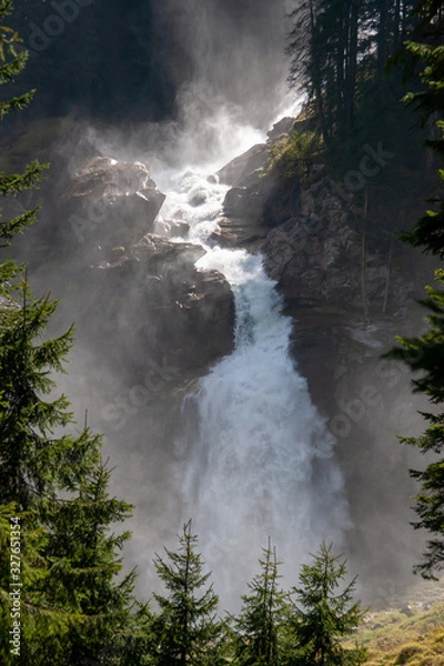 Obraz A view of the raging Alpine waterfall shrouded in water fog