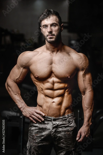 Fototapeta Bodybuilder athletic man workout muscles exercise.