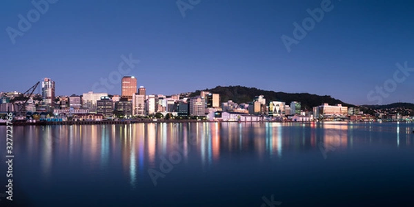 Obraz Wellington, New Zealand city buildings and skyline reflected in the harbour at sunrise on a perfect summer morning. 