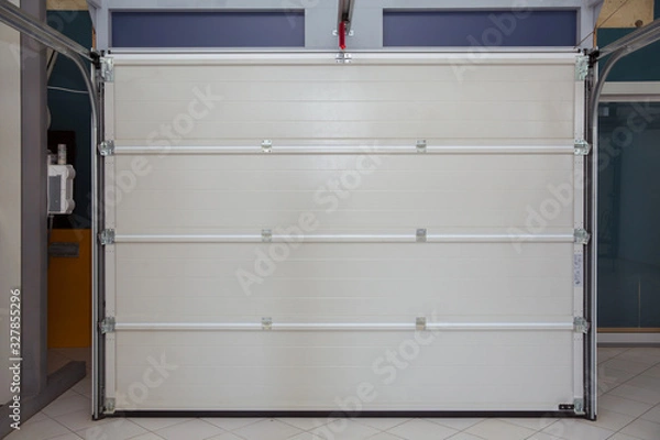 Obraz Shutter door or roller door and concrete floor outside .White Automatic shutters in a house . gates in the garage . Automatic Electric Roll-up Gate Or Push-up Door In The Modern Building  .