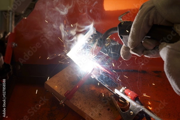 Fototapeta Dazzling light of welding work