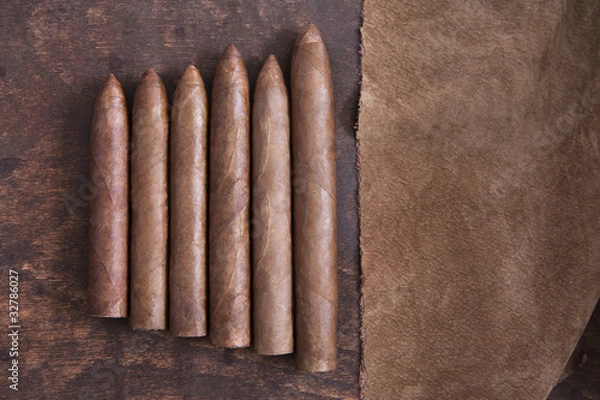 Fototapeta Cigars and brown cloth on the table