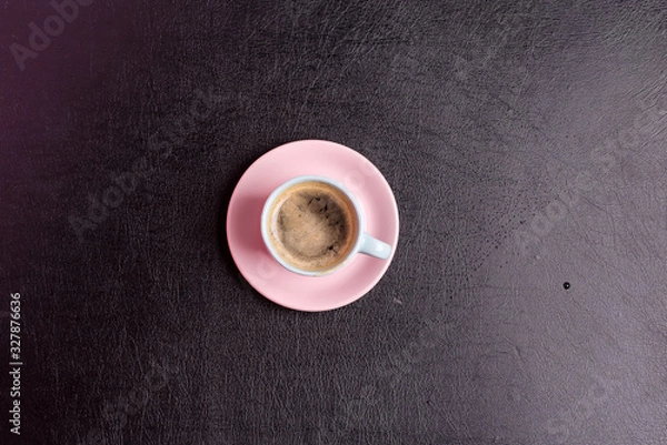 Fototapeta Freshly brewed aromatic coffee drink on a background from decorative black artificial eco leather. Top view.