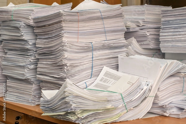 Fototapeta bundles bales of paper documents. stacks packs pile on the desk in the office
