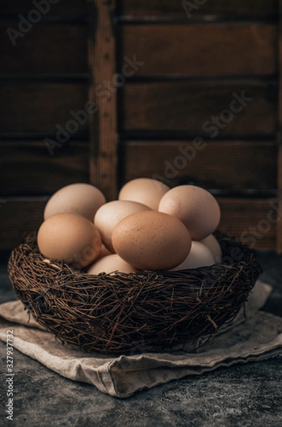 Obraz Easter organic eggs in nest on wooden background