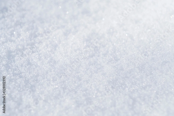 Fototapeta Background of fresh white snow. Winter snowflakes texture. Snow white texture winter background. Icy surface pattern. Shiny snow with bokeh