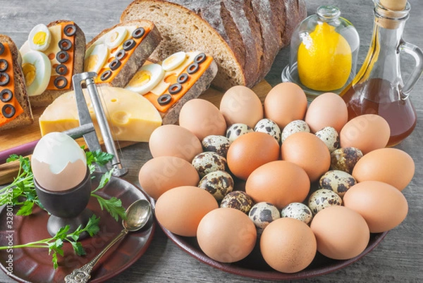 Obraz Egg table setting with cheese, lemon, bread and parsley.