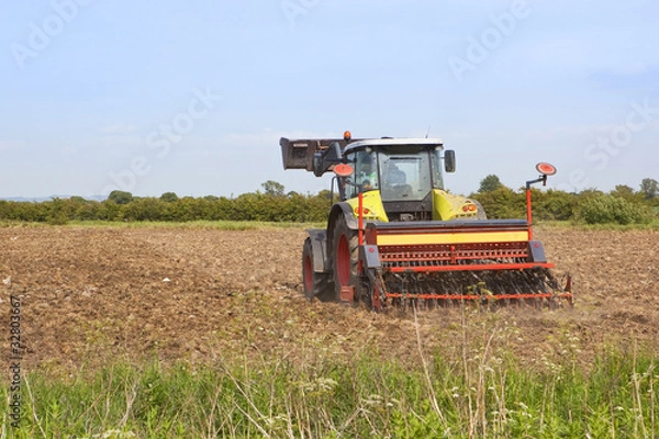 Fototapeta harrowing a field