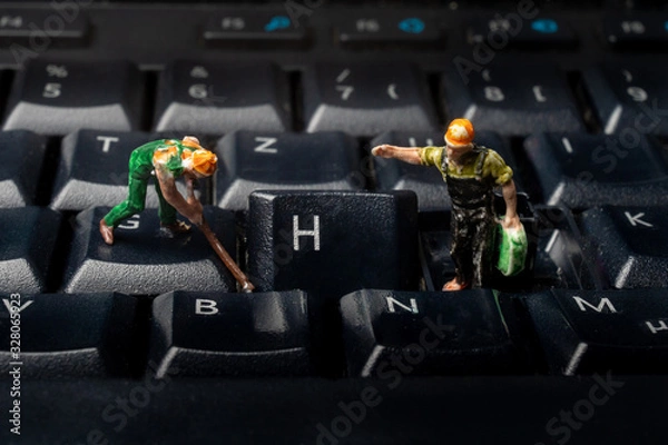 Obraz Two workers repairing a computer keyboard