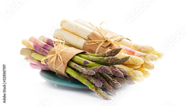 Fototapeta Green and white asparagus on a green plate, isolated on white