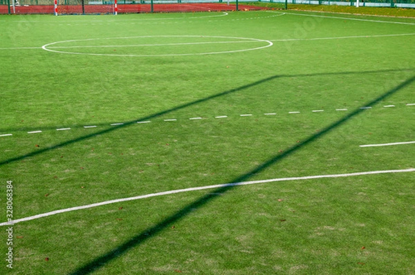 Fototapeta Closeup of green grass surface on soccer court