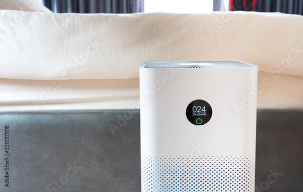 Fototapeta Indoor air purifier with digital monitor screen in bedroom, that show air quality in the room and air pollution levels in the room. PM 2.5 is a major environmental health problem affecting everyone.