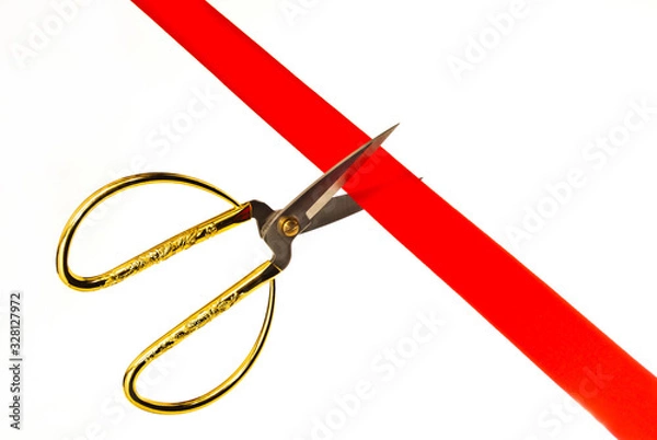 Obraz Cutting a red ribbon with scissors.