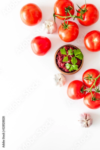 Fototapeta Tomato frame with suase and garlic on white background top-down copy space