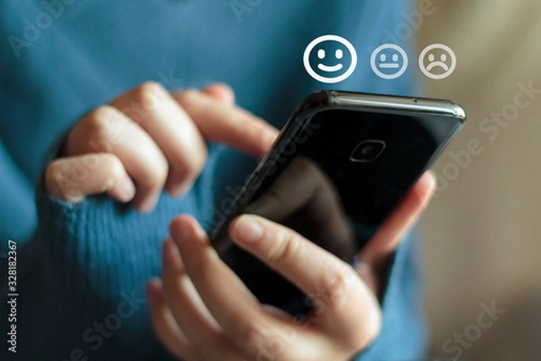 Fototapeta Woman using phone for service rating and customer satisfaction