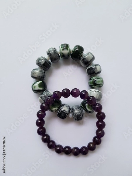 Obraz Closeup of colorful bead bracelets white background.  Ornament concept.