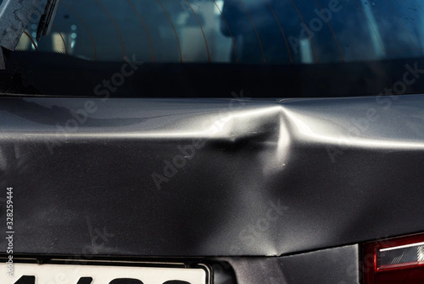 Obraz A dent in the body of a silver car