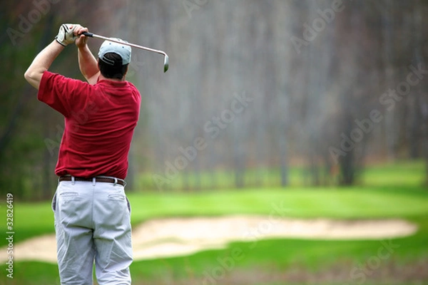 Fototapeta A man enjoying a game of golf