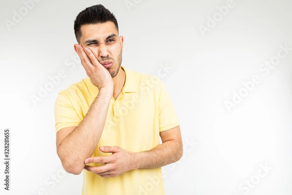 Fototapeta bored man on a white studio background with copy space