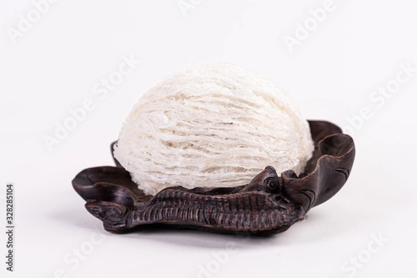 Obraz The snow-white bird's nest is a popular food，Dried swiftlet nests ready for cooking on white background.