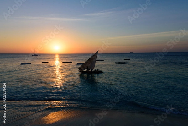 Fototapeta Sunset over a fisher boat at the  West coast of Sansibar, East Africa, August 2017, Tanzania