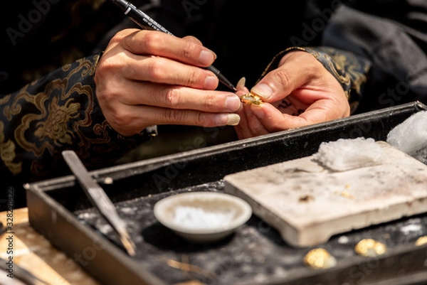 Fototapeta The processing of traditional Chinese silver ornaments