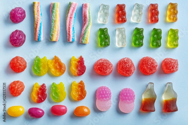 Fototapeta Candy variety flat lay on a blue background viewed from above. Top view