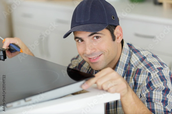 Fototapeta man installing kitchen - diy concept