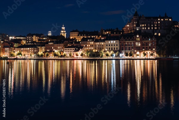 Obraz View of Sodermalm with illuminated historical buildings during the night in Stockholm, Sweden.