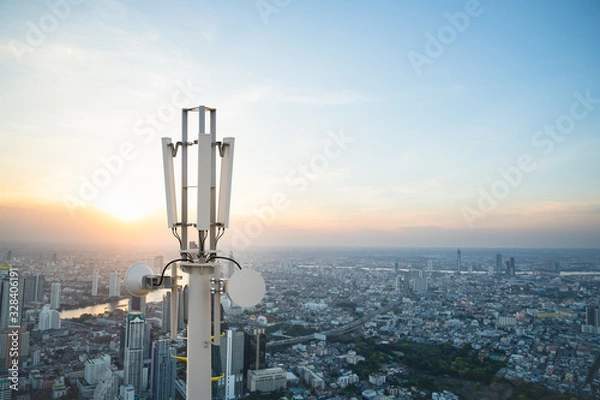 Fototapeta Telecommunication tower with 5G cellular network antenna on city background
