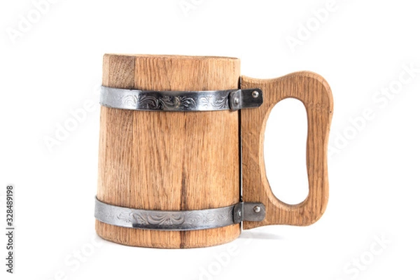 Fototapeta Wooden beer mug stands on a table on a white background sideways.