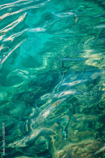 Fototapeta clear turquoise sea ocean water surface with ripples low waves on seascape background